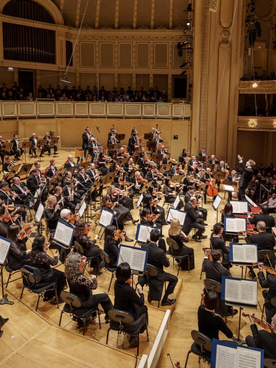 from the side of the stage, the chicago symphony orchestra performs in  Orchestra Hall