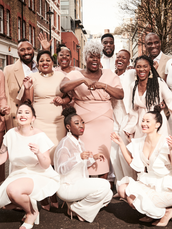 in light neutrals and blush tones, the singers of the kingdom choir pose in an intersection in london