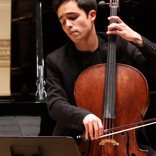 a young dark-haired man plays a cello