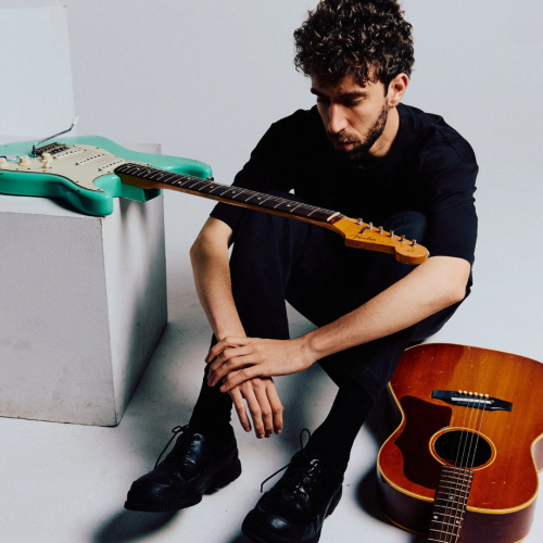 guitarist ely perlman, portrait with electric and acoustic instruments