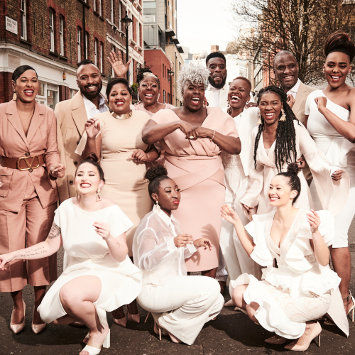 in light neutrals and blush tones, the singers of the kingdom choir pose in an intersection in london