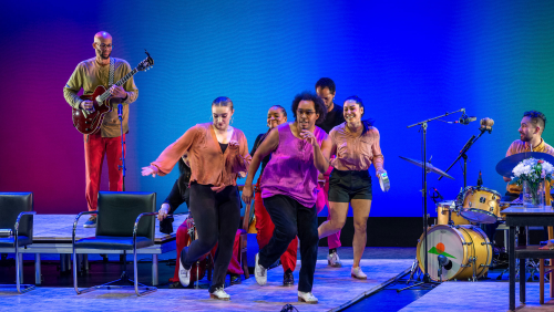 dancers and musicians perform tap dance in a colorful, fun performance