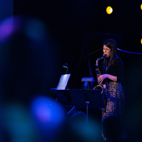 saxophonist melissa aldana performs as audience members watch