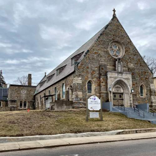 A large stone church on a gray winter day