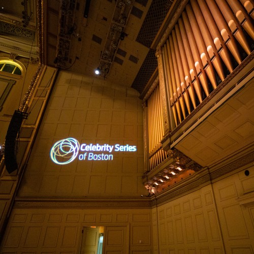 detail of the Celebrity Series logo projected on the wall at Symphony Hall next to the organ pipes