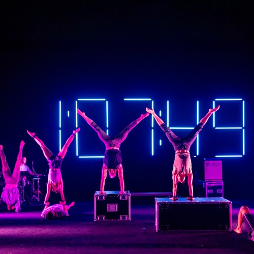 Circus company Gravity and Other Myths, in performance, all doing handstands