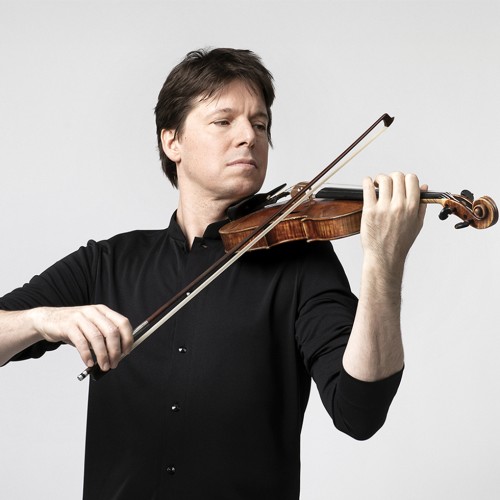 Joshua Bell, a white man with brown hair plays violin in a black shirt in front of a white background. 