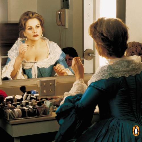 a book cover showing an opera singer, looking in the mirror in costume and stage makeup.