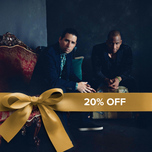 two cuban men sit leaning forward on elegant and luxurious furniture. A ribbon overlay reads 20% off
