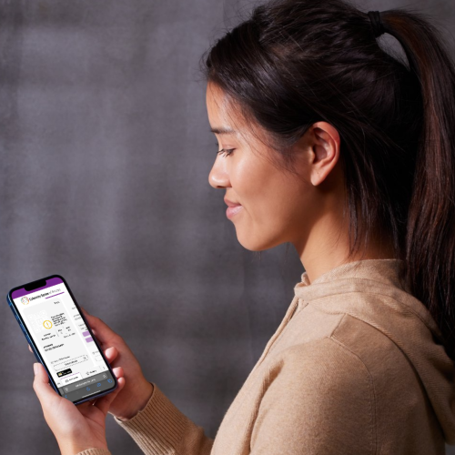 a young woman holds a phone showing a Celebrity Series digital ticket