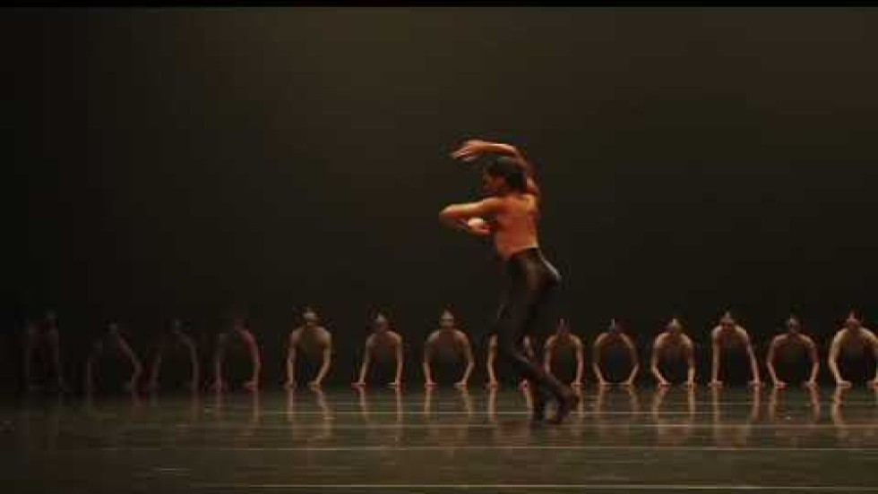 a large company of dancers in a contemporary work