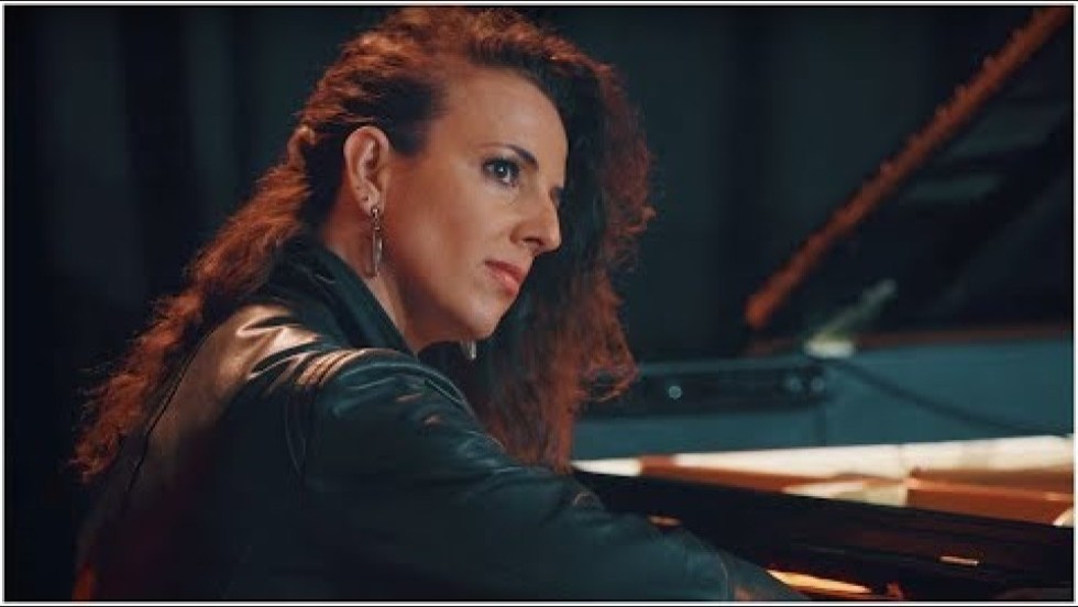 a piano quatet performs on a warmly lit stage