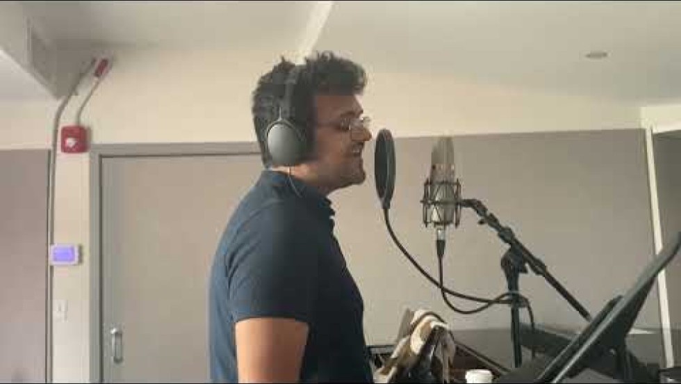 Individually recorded in a music studio, a bass player, vocalist, and drummer, and other musicians perform