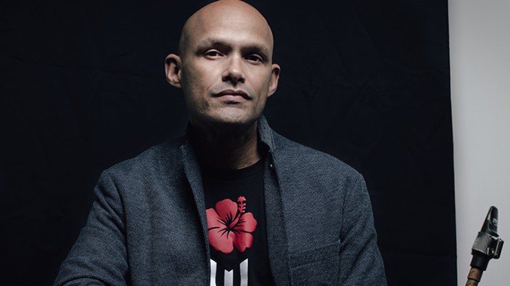 saxophonist miguel zenon holds his alto sax across his lap