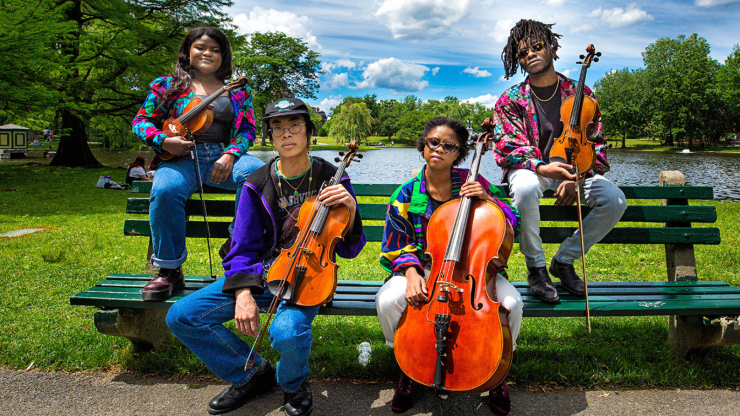 the nebulous quartet hold their instruments in the boston public garden