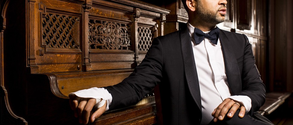 Jason Moran, a black man in a tuxedo sitting in front of a piano.