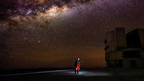 Under a brilliant night sky, Yo-Yo Ma holds his cello near the observatories in the Atacama Desert