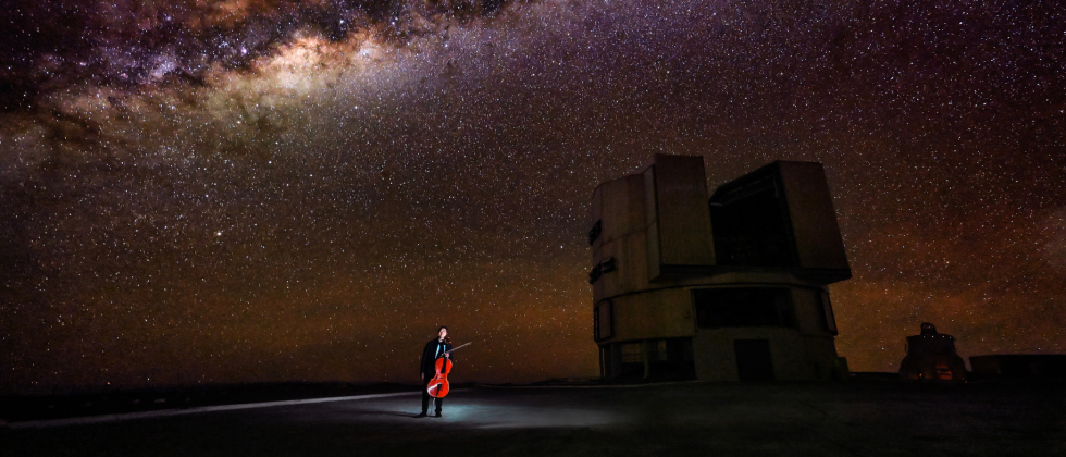 under a brilliant night sky in the Atacama Desert, Yo-Yo Ma holds his cello near two observatories.