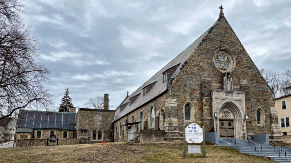 A large stone church on a gray winter day